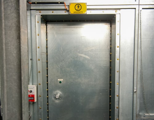 A yellow argonite sign hangs above the door in the e-bunker