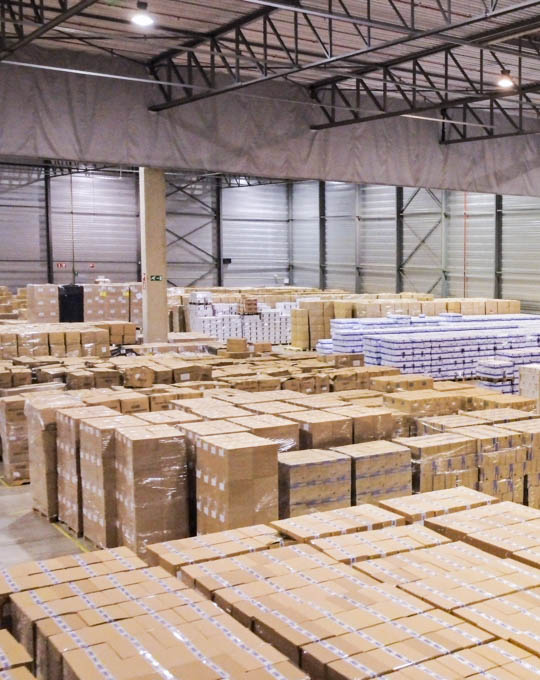 An image of a storage space with numerous boxes stacked on top of each other, illustrating a well-organized storage facility.