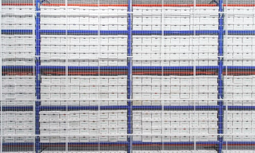 A wall made of shelves filled with Merak archive boxes
