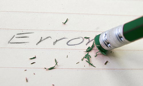 A green pencil erases the word error