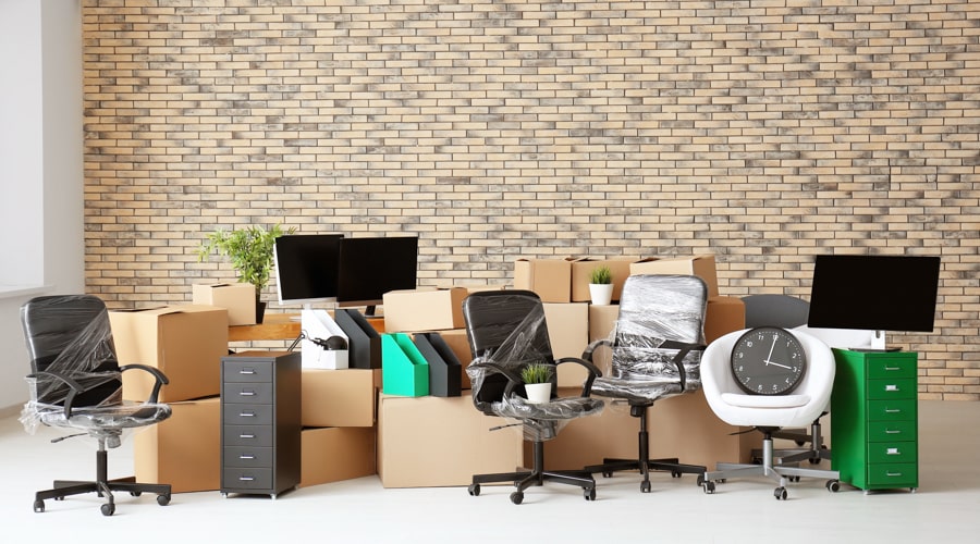 An office space with all items packed in boxes and wrap